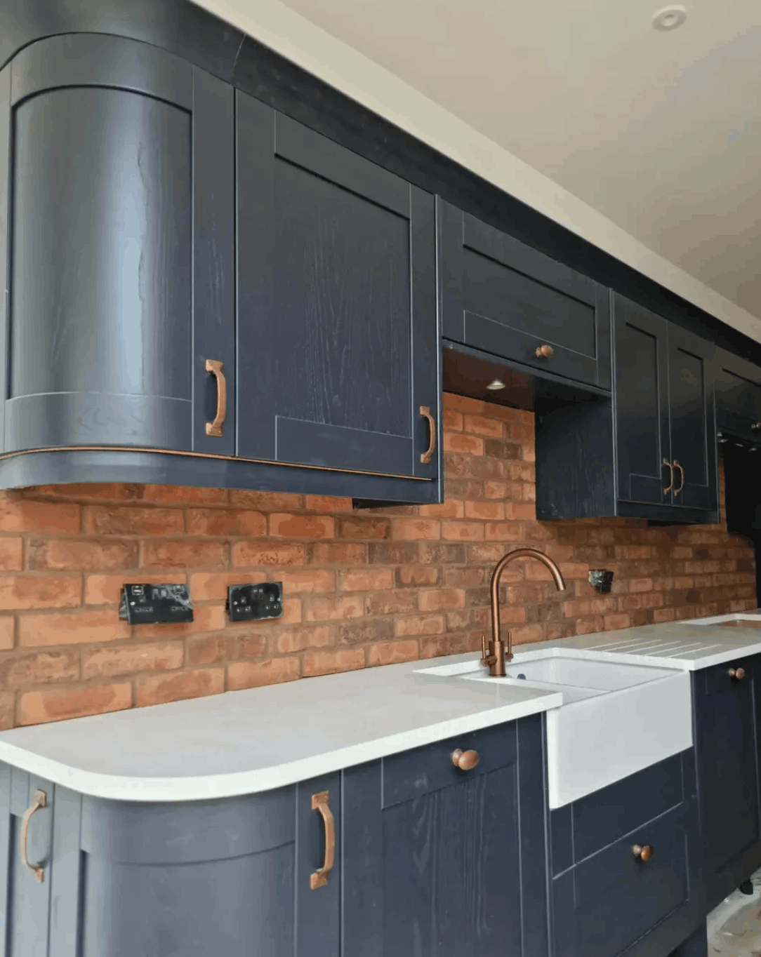 Navy Kitchen with Exposed Brick Splashback